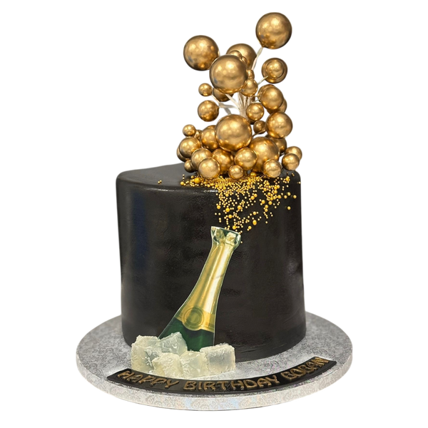 Buttercreme Torte mit Champagnerflasche und Gold Kugeln