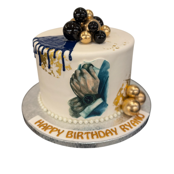 "Elegante Torte mit Schoko-Drip, goldenen und schwarzen Kugeln sowie einem Motiv, das einen Mann zeigt, der sich eine Uhr ums Handgelenk bindet. Perfekt für stilvolle Anlässe."