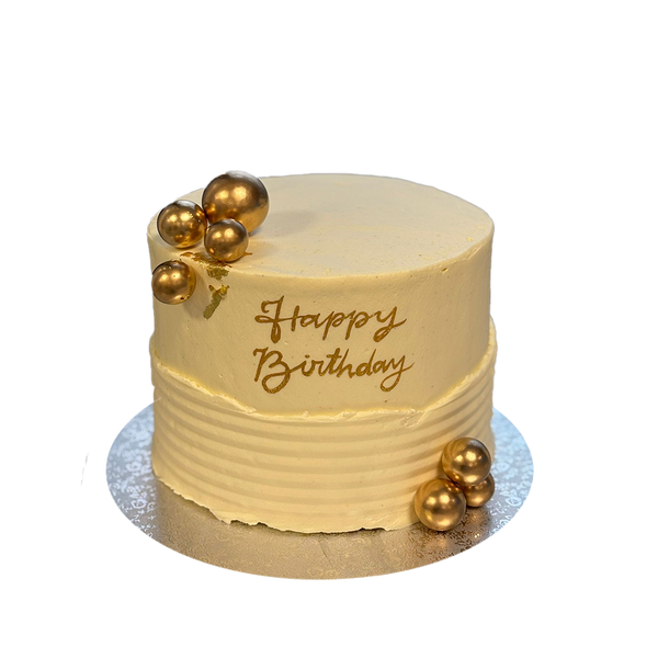 Weiße Torte mit Struktur mit Goldkugeln