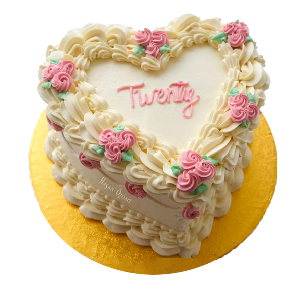 Weiße herzförmige Coquette-Torte mit  pinker Spritzdeko