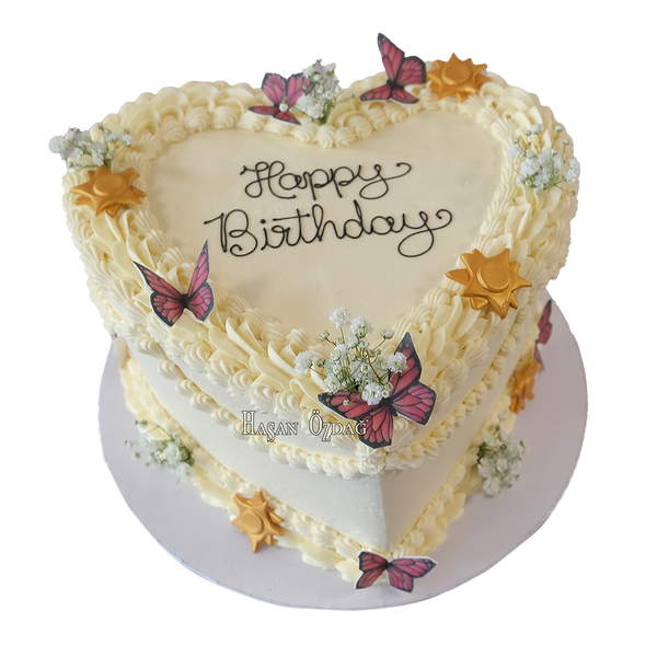 Weiße herzförmige Coquette-Torte mit Schmetterlingen, Schleierkraut und Sonnen