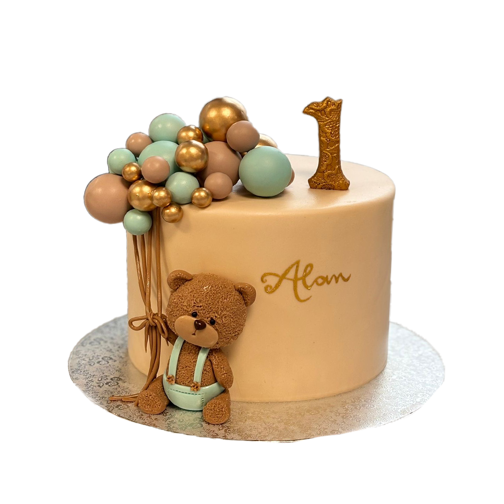 Beige Bärchentorte mit Kugeln in blau, beige und gold. Zudem gibts nen Teddy in Latzhose
