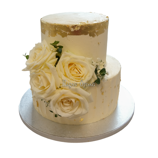 Zweistöckige Torte mit Blattgold und Rosen