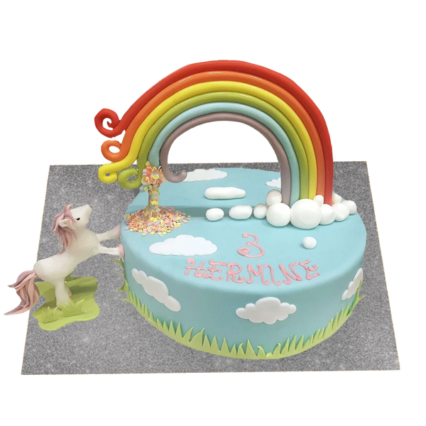 Blaue Einhorntorte mit Regenbogen, Wolken und Einhorn