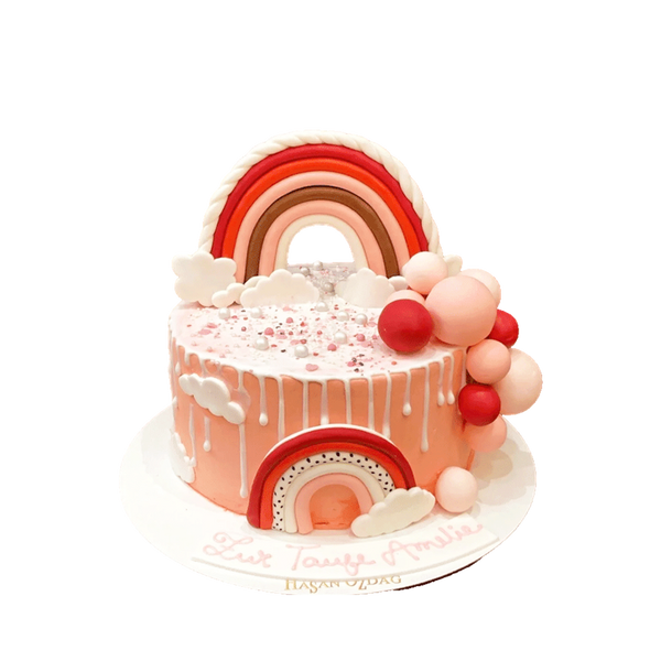 Rosa Torte mit rosa Regenbogen, Drip, Wolken und Kugeln
