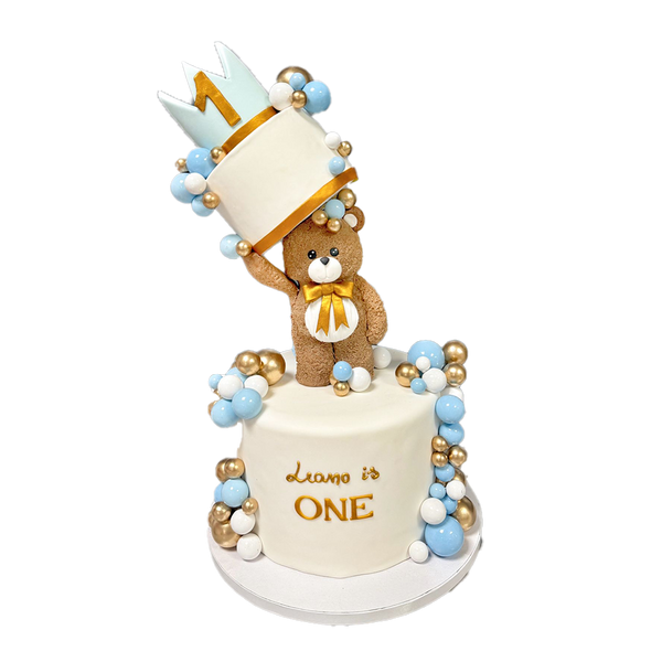 Weiße Teddytorte mit Teddy, Krone blauen, goldenen und weißen Kugeln