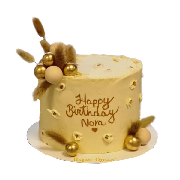 Beige Torte mit Getreide, Schrift, Spritzern und Kugeln
