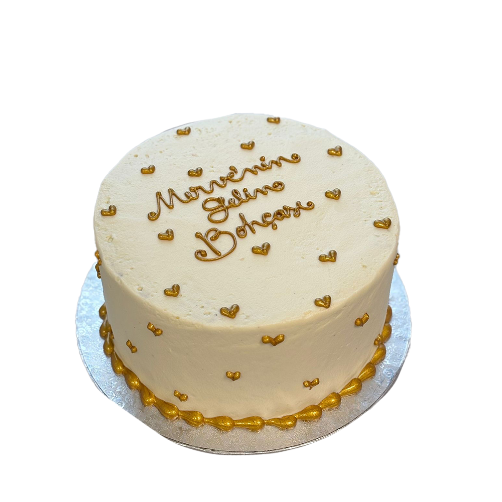 Weiße Torte mit goldenen Herzen
