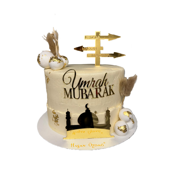 Beige Umrah Mubarak Torte mit Kugeln und Golddeko
